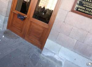 People throw coins in the direction of the Ministry of Finance