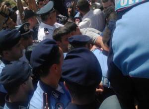 Police officers do not allow protesters to approach PSRC building