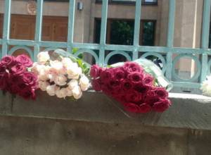 People place flowers in front of French Embassy in Yerevan for the victims of Nice attack