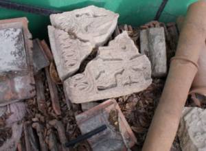 Cross-stones in pile of garbage