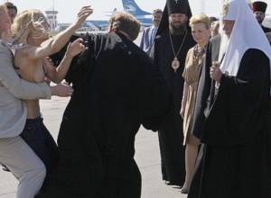 Patriarch greeted by naked feminist