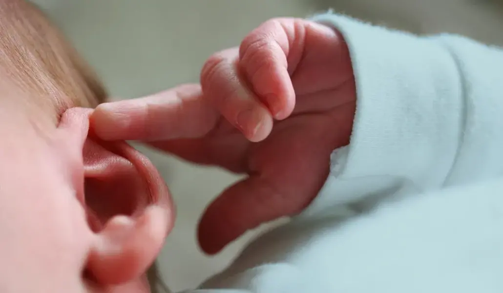 baby_touching_ear-1296x728-header